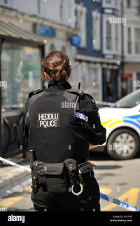 rear-view-of-a-dyfed-powys-police-force-woman-constable-wales-uk-C4155P.jpg