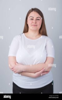 Beautiful chubby girl in 30s posing in studio wearing casual white t shirt with crossed handsl