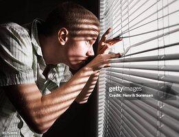 man-looking-through-the-blinds.jpg