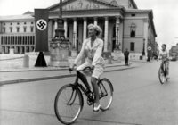 Beautiful and elegant fraulein ride a bike in National Socialist Germany