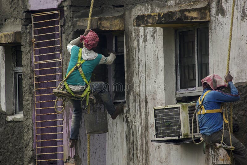 th-february-kolkata-west-bengal-india-two-construction-workers-doing-repair-work-outer-wall-hanging-rope-selective-241948155.jpg