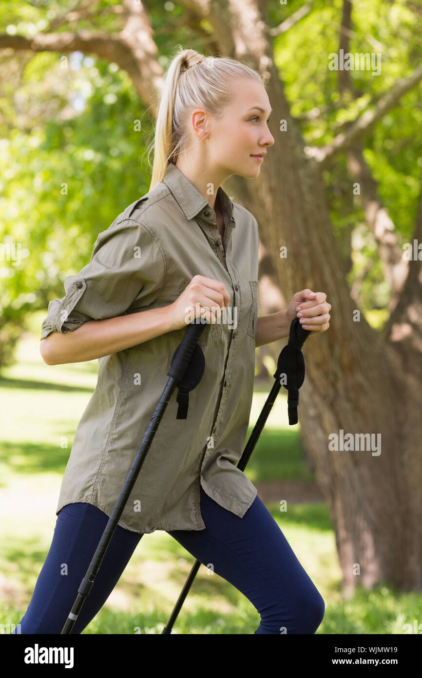 side-view-of-a-beautiful-young-woman-nordic-walking-in-the-park-WJMW19.jpg
