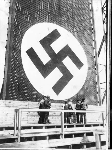 One of the huge swastika signs being hung during preparations for a May Day rally where Hitler will address a crowd of nearly 2 000 in the Tempelhof...