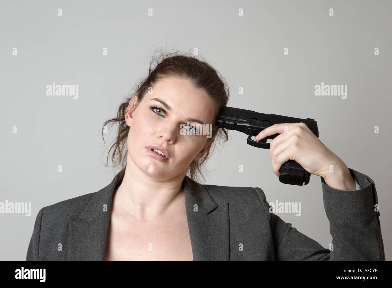 business-woman-holding-a-gun-to-her-head-JA8CYF.jpg