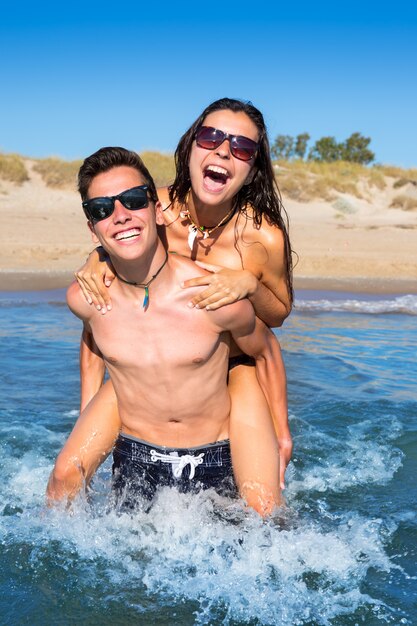 teen-couple-enjoying-piggyback-summer-beach_79295-2668.jpg