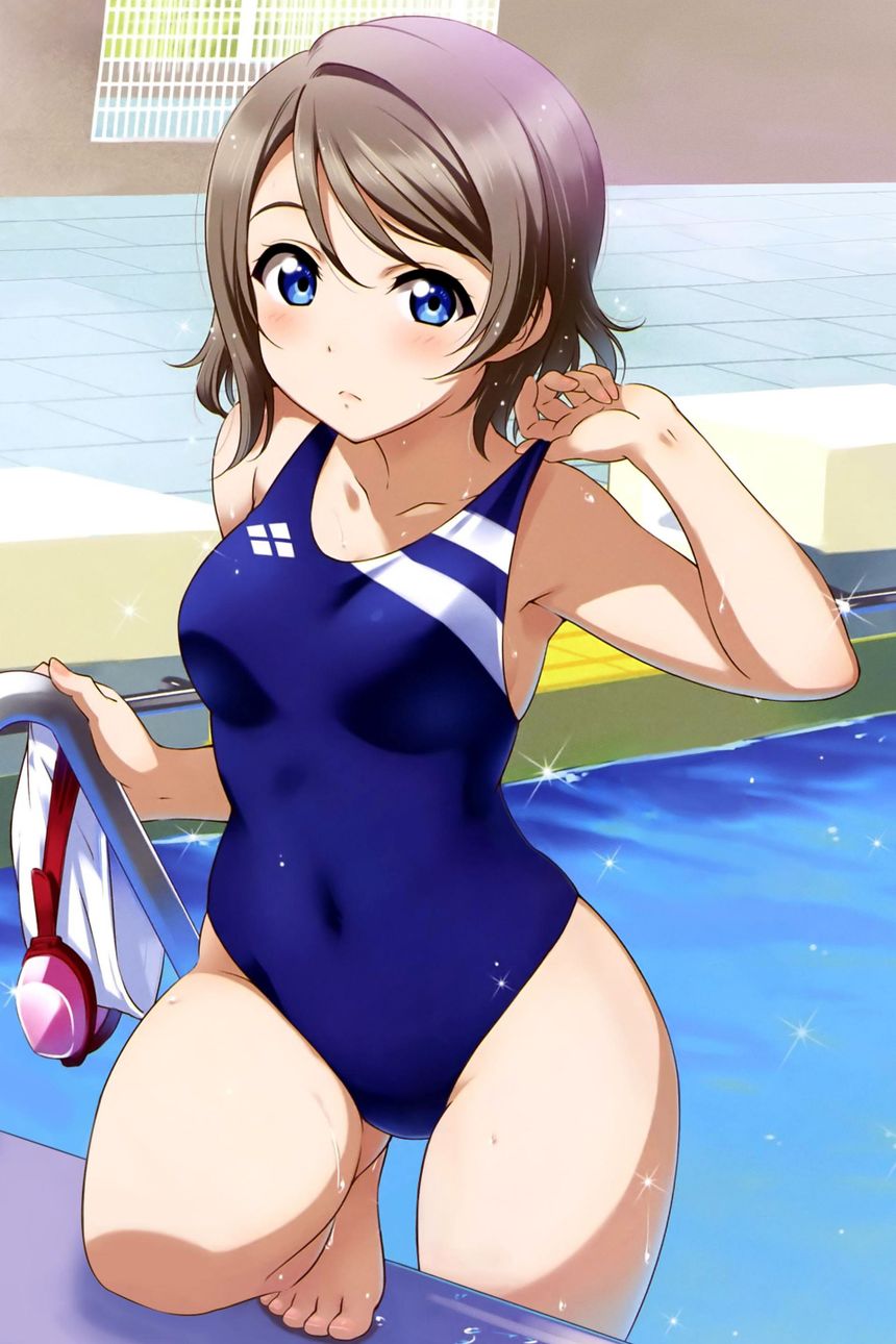a woman in a blue swimsuit standing next to a swimming pool with her hand on her hip