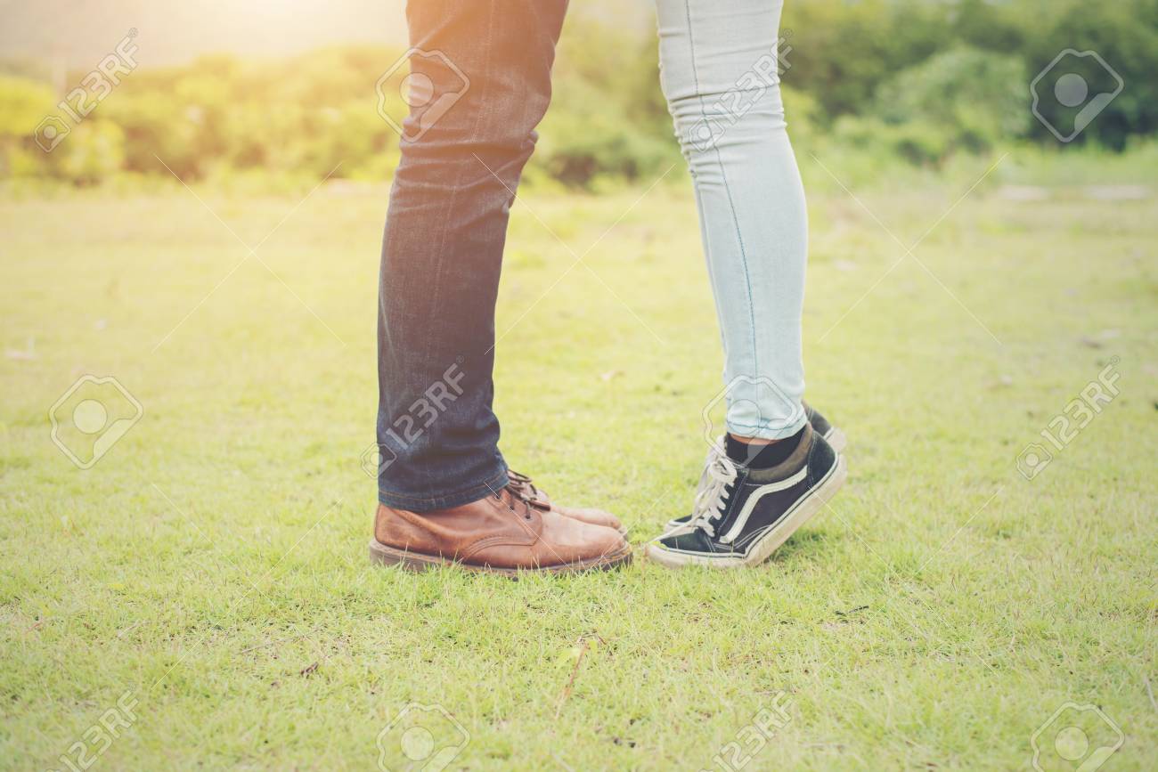 77297084-feets-of-young-couple-kissing-summer-grassland-.jpg