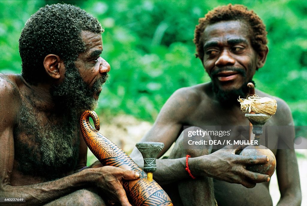 pygmy-men-smoking-marijuana-uganda.jpg