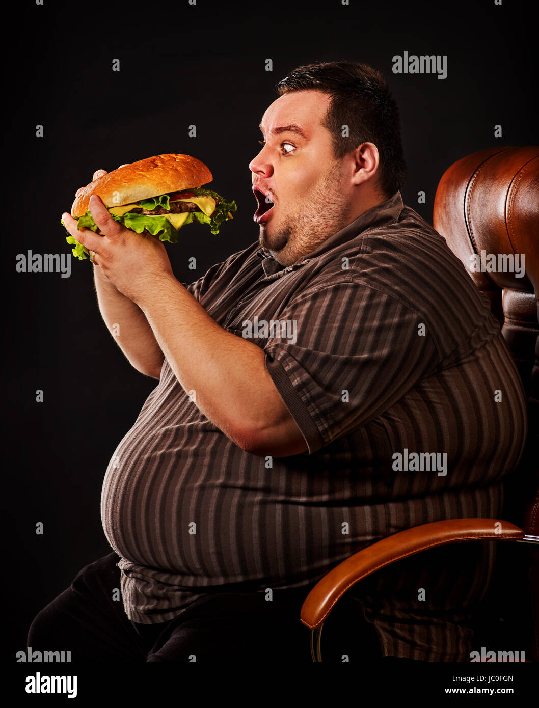Diet failure of fat man eating fast food hamberger. Happy overweight person  spoiled healthy food by greedily eating huge hamburger. Junk meal leads to  Stock Photo - Alamy
