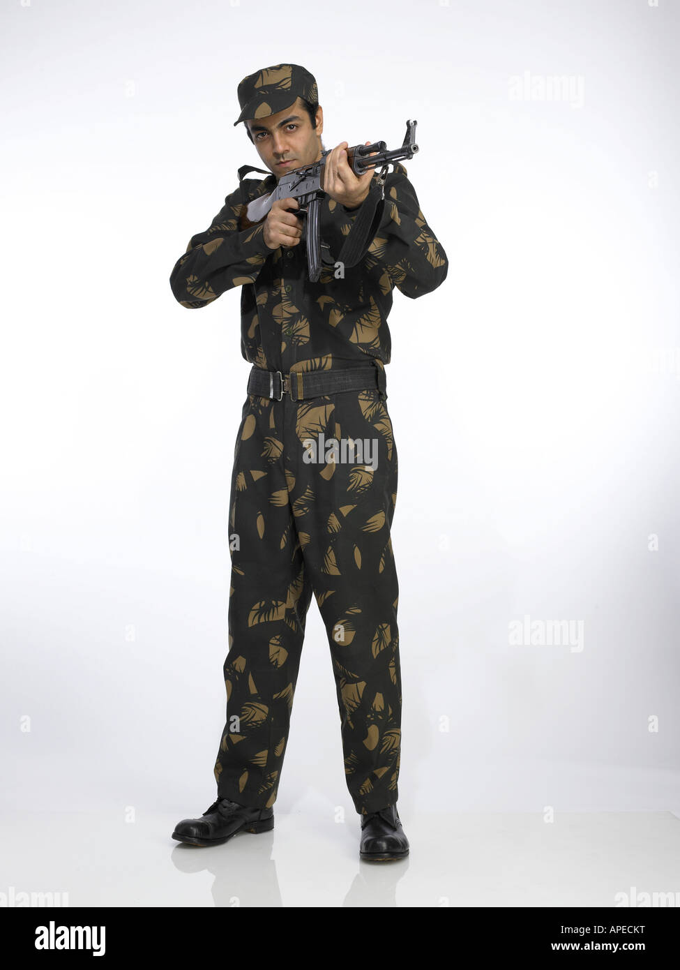 indian-army-soldier-standing-and-pointing-ak-47-gun-APECKT.jpg
