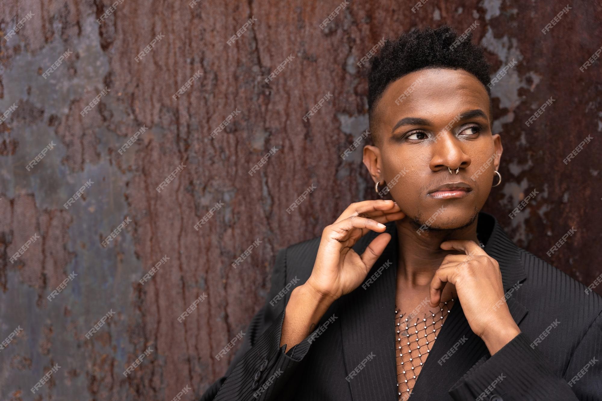 Premium Photo | A black ethnic man in a fashion pose on a brown metallic  background