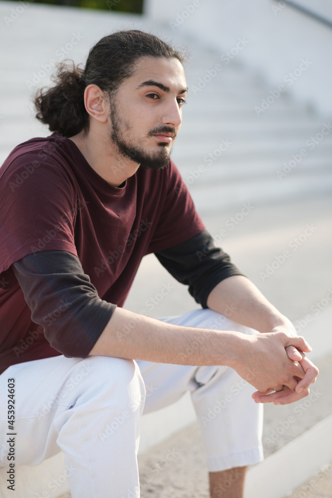 Close up portrait of handsome Arab man walking in the park Photos | Adobe  Stock