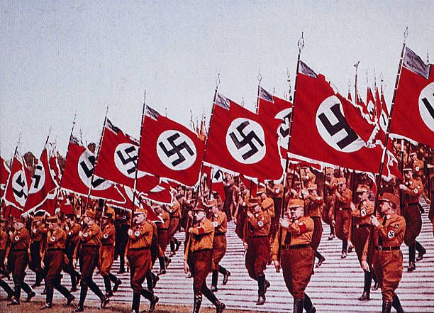 German SA Troops Marching with Nazi Flags at Rally, Nuremberg, Germany, 1933.