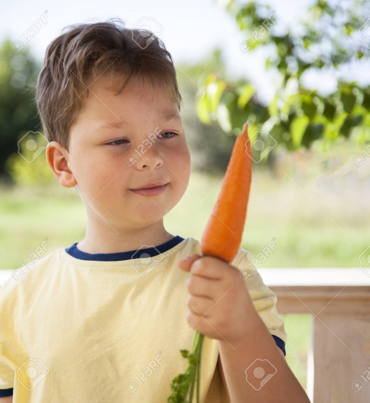 113429690-happy-boy-biting-the-carrot-a-child-with-a-vegetable-kid-eating-fresh-carrots.jpg