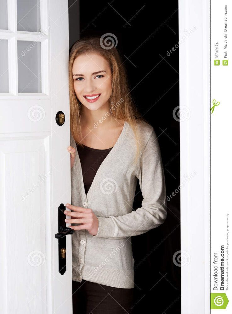 Beautiful caucasian woman standing door opening them 36849174
