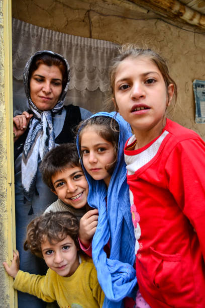 group-portrait-of-kurdish-family-consistent-of-mother-and-children-at-the-door-of-their-home.jpg
