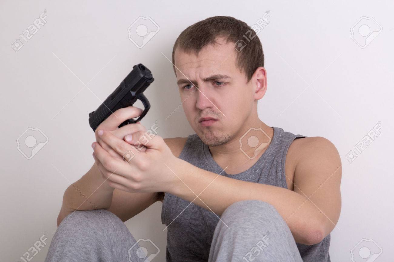 36268608-suicide-concept-stressed-young-man-with-gun.jpg