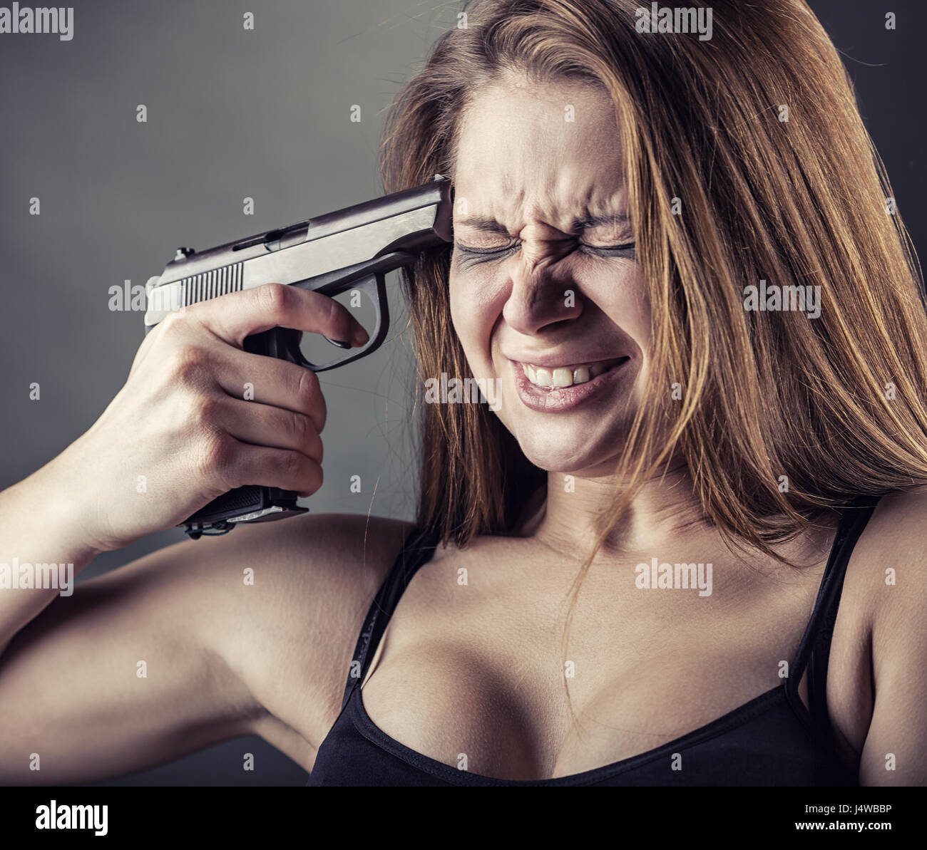 woman-with-pistol-pointing-on-her-head-J4WBBP.jpg