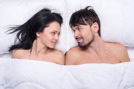 34679446-young-happy-couple-in-a-bed-top-view-they-are-looking-at-each-other-.jpg
