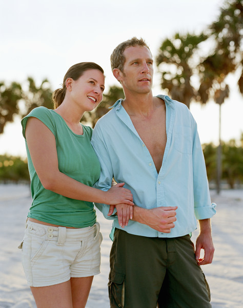 Couple on beach, woman holding man's arm, smiling Free Photo Download |  FreeImages