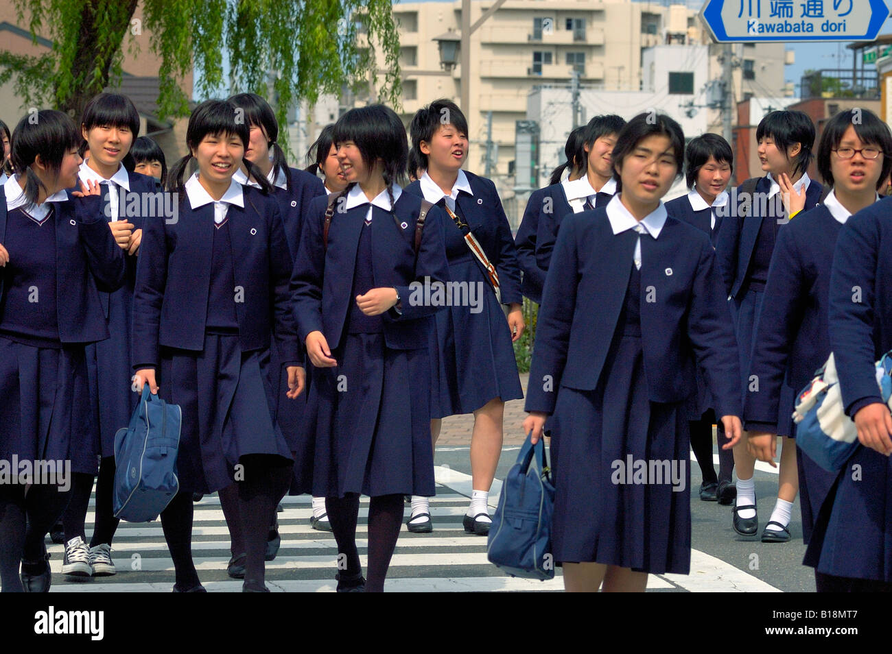 girls-at-crosswalk-in-school-uniform-kyoto-japan-B18MT7.jpg