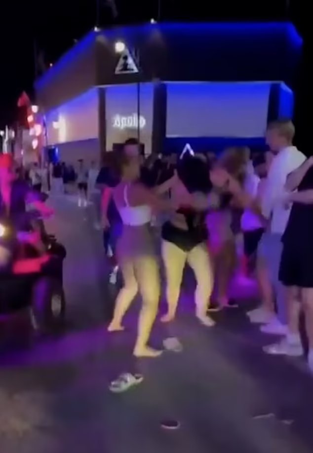 two-women-street-fight-man-916246794.jpg