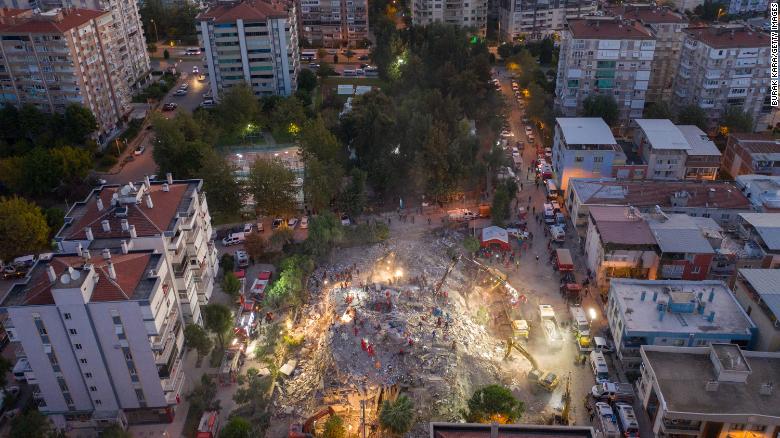 Emergency services personnel search the scene for survivors in Izmir on Saturday.