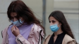 Krestina (left) and Angelina Khachaturyan, two of the three sisters accused of killing their father, arrive for a court hearing in Moscow in July. 