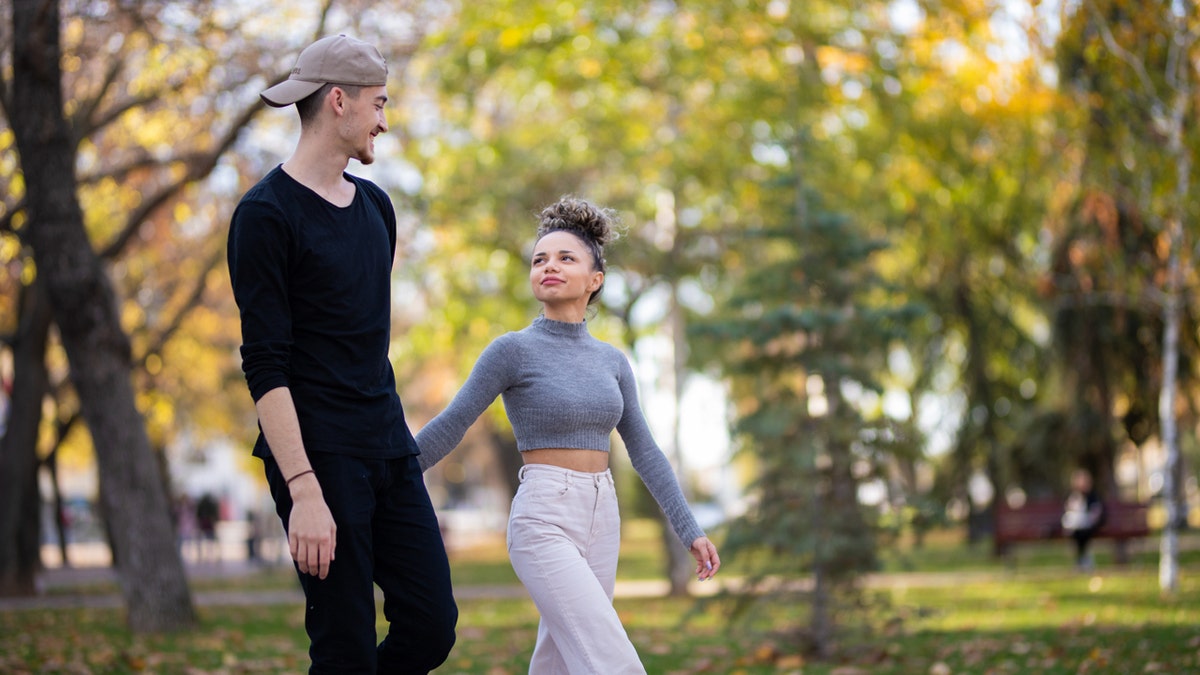 iStock-1353417830-really-tall-man-and-short-woman-walk-hand-in-hand.jpg