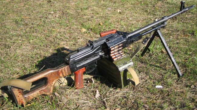 Current issue, early production Kalashnikov PKM machine gun, loaded with 100-round belt in box and ready to fire.