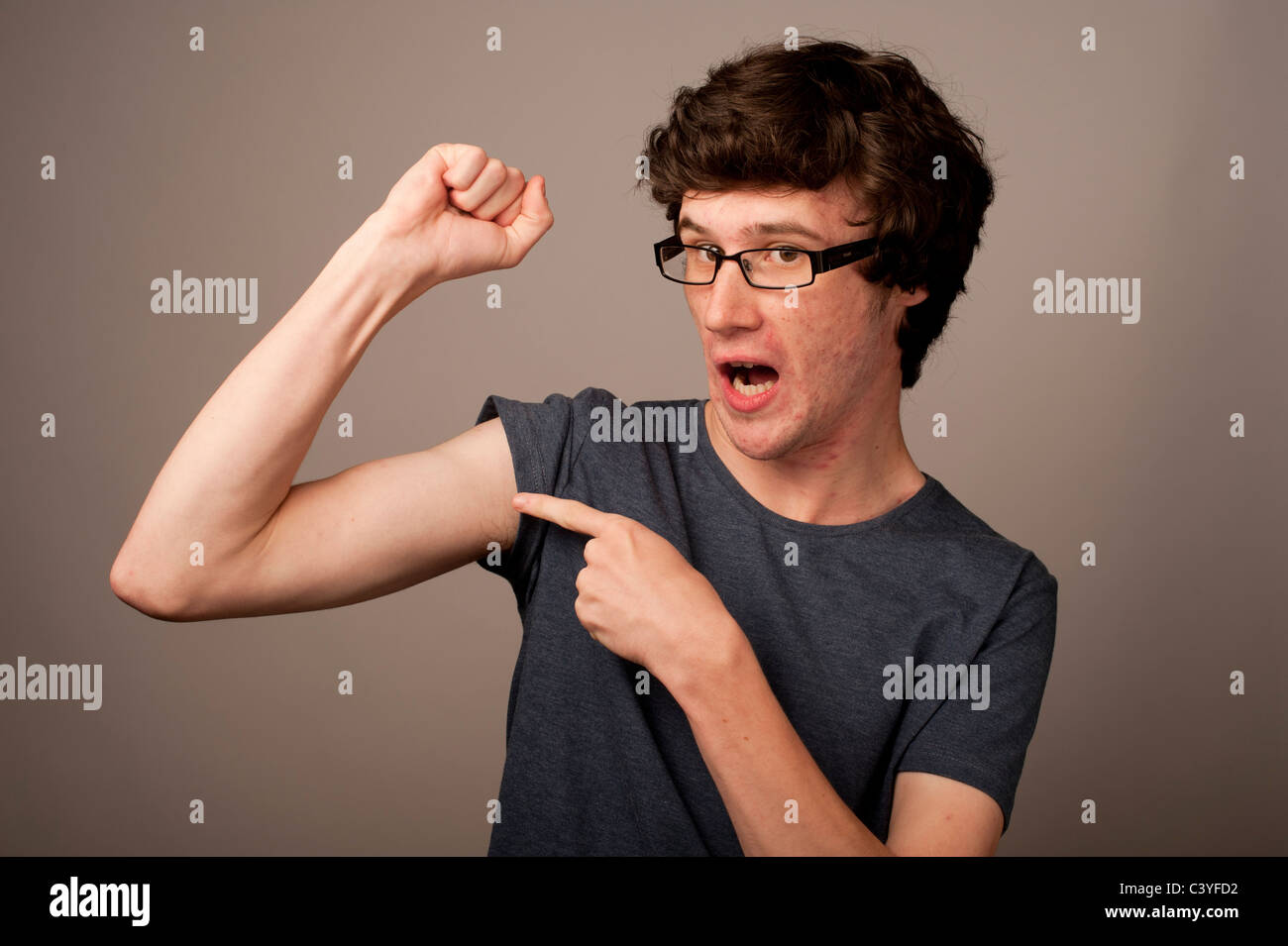 a-spotty-faced-weak-feeble-geek-nerd-young-man-with-thin-arms-wearing-C3YFD2.jpg