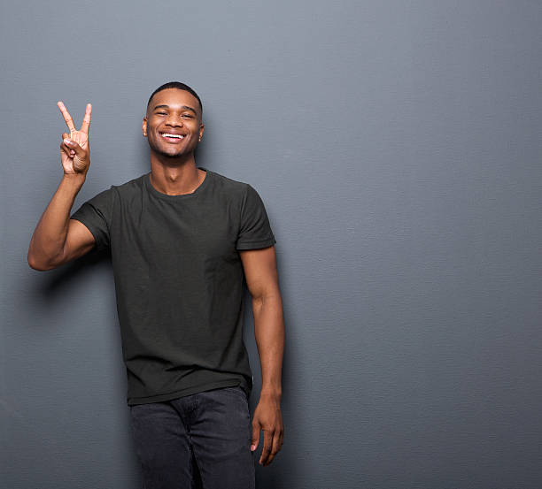 young-man-smiling-showing-hand-peace-sign.jpg