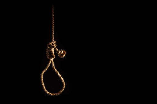 noose-of-braided-rope-on-a-gloomy-dark-background-failure-or-suicide-picture-id1157887651