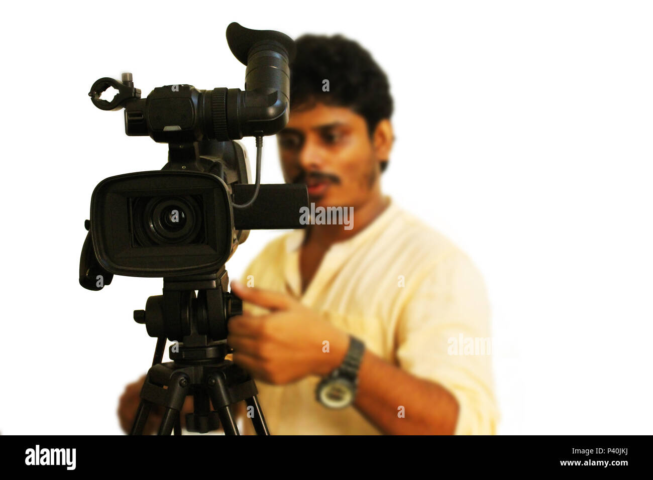 Video camera operator filmed on white background Stock Photo - Alamy