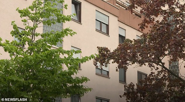 The newborn was dropped 12 feet out of an apartment window onto the tarmac below (Pictured, general view of the apartment building)