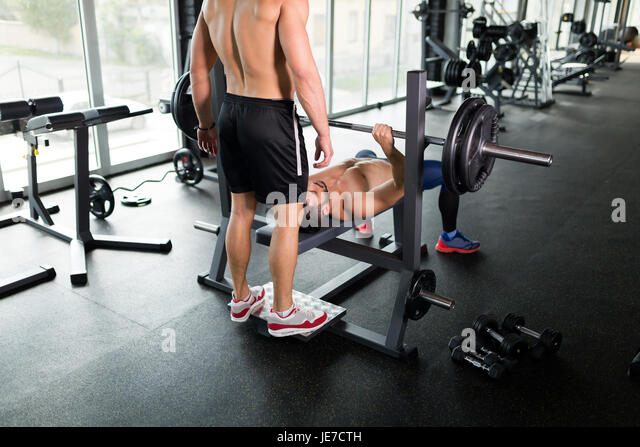 handsome-young-muscular-man-doing-bench-press-and-gets-help-je7cth.jpg
