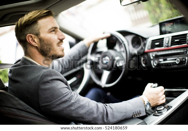 young-man-driving-modern-car-600w-524180659.jpg