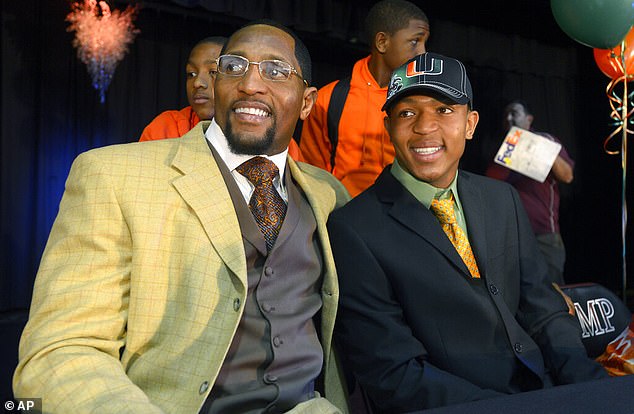 Ray Lewis III, right, poses for photos with his father, former Baltimore Ravens linebacker Ray Lewis
