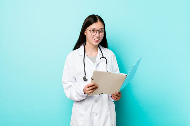 young-asian-doctor-woman-holding-folder_1187-33444.jpg