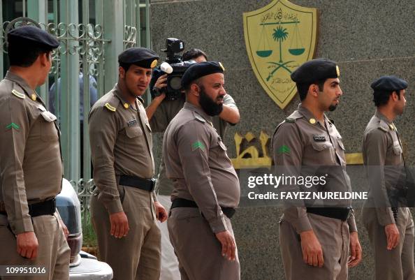 saudi-policemen-stand-guard-in-front-of.jpg