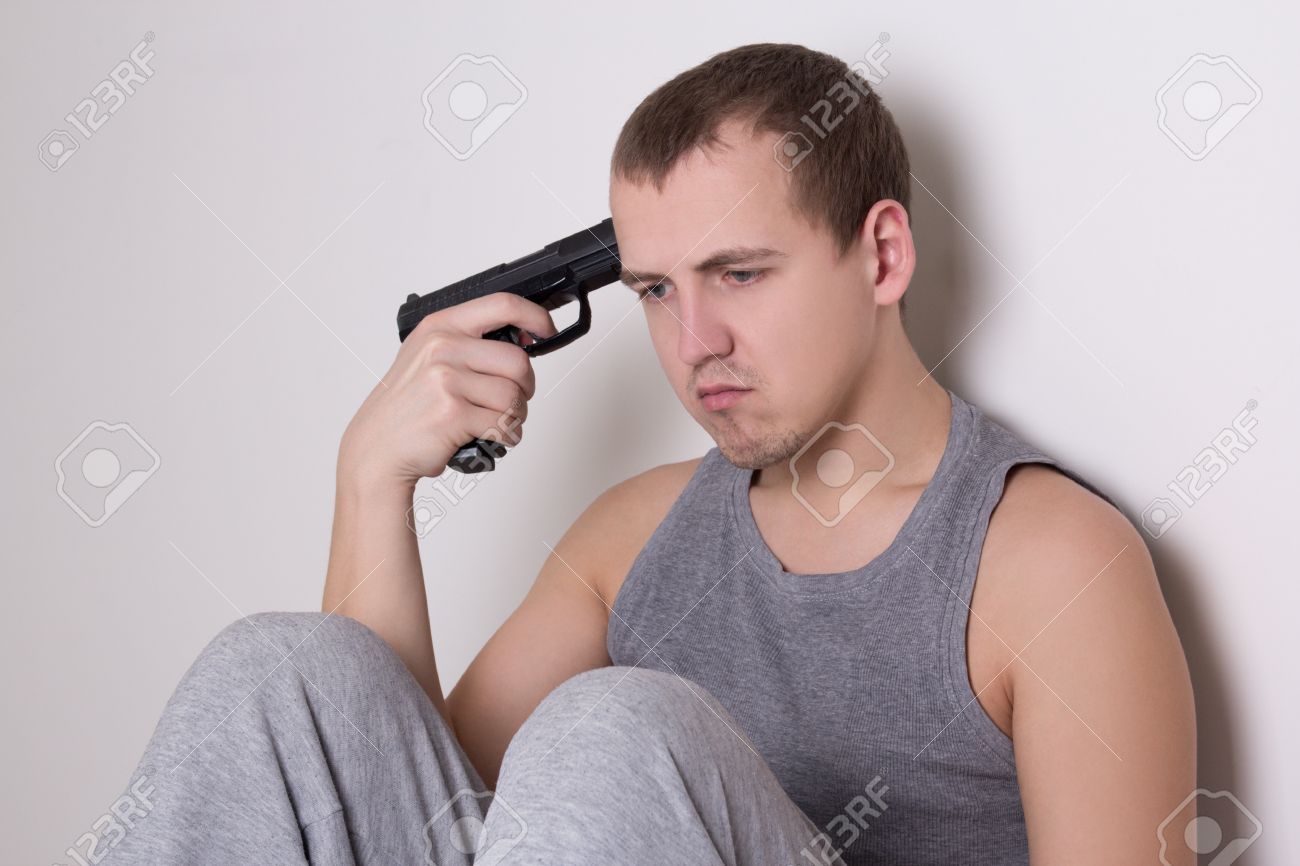 36268610-young-sad-man-sitting-with-gun-trying-to-make-suicide.jpg