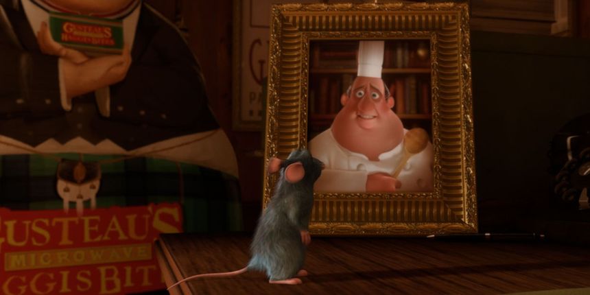Remy stands in front of Gusteau's photo in Ratatouille.