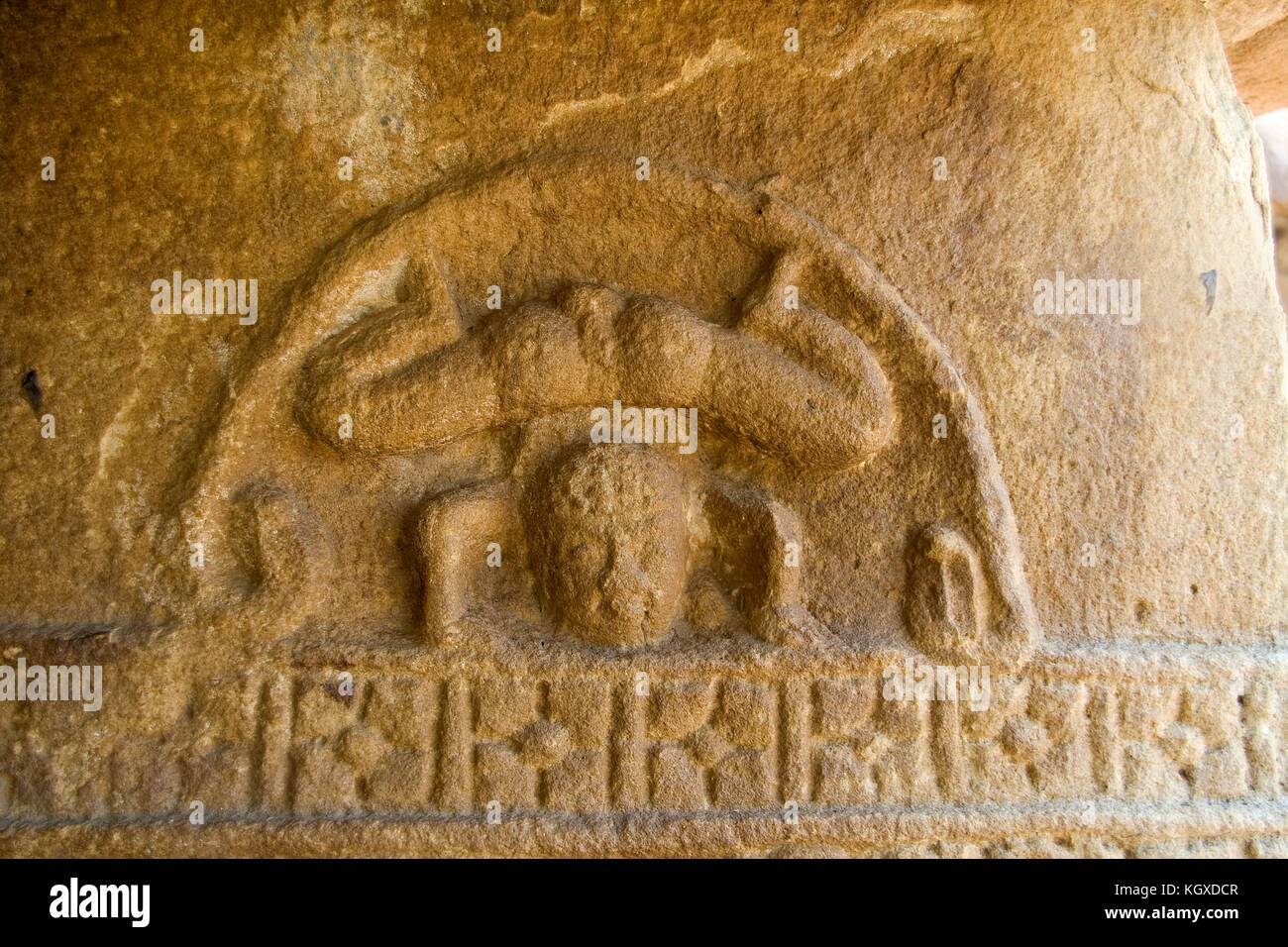 seershasana-head-down-yoga-pose-carved-on-stone-pillar-in-ladkhan-KGXDCR.jpg