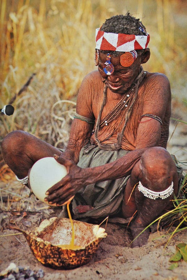 botswana-old-san-woman-preparing-oostrich-egg-food-later-empty-eggs-filled-water-stored-underneath-sand-223403348.jpg