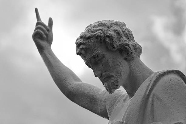 jesus-statue-with-finger-pointing-at-the-sky-monochrome-picture-id535492487