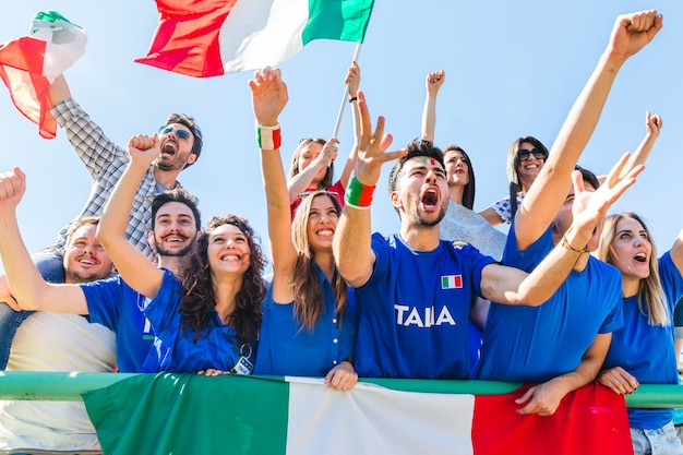 italian-supporters-celebrating-stadium-with-flags_108072-2396.jpg
