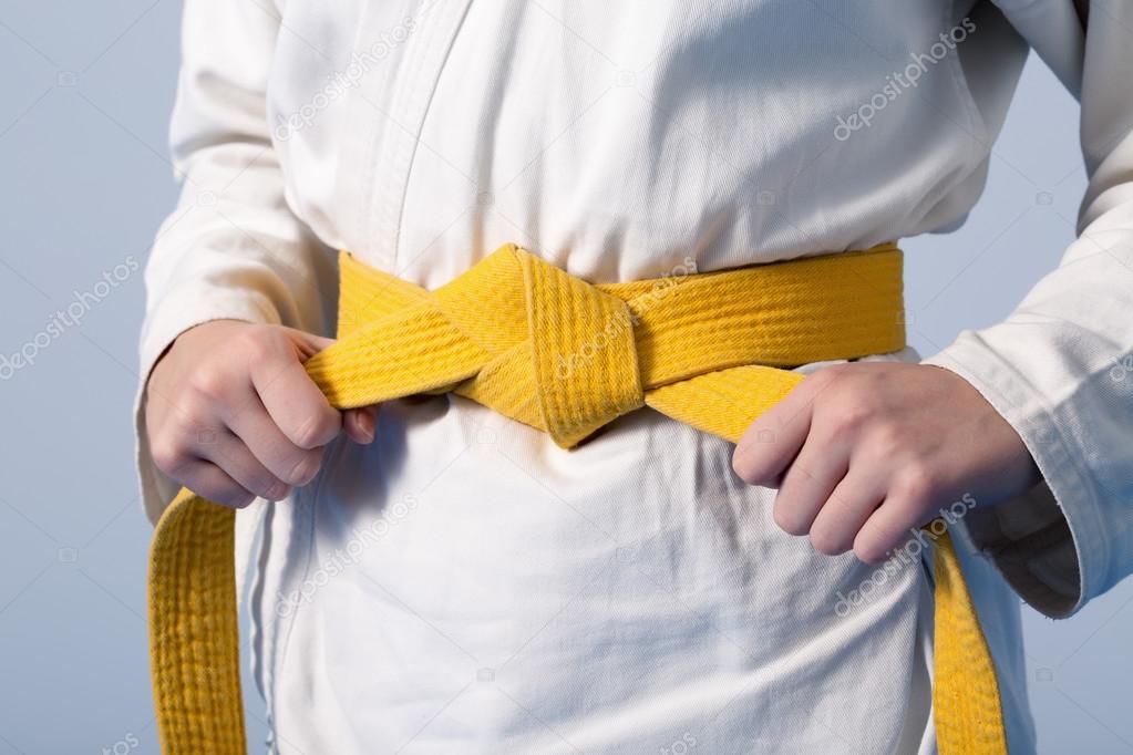 depositphotos_92123744-stock-photo-hands-tightening-yellow-belt-on.jpg