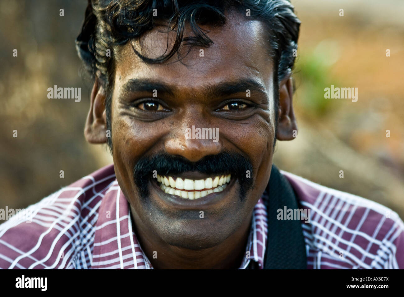 indian-man-with-a-big-smile-in-cochin-india-AX6E7X.jpg