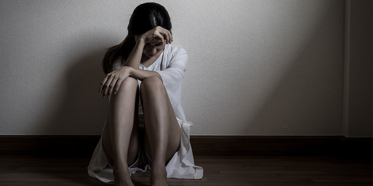 woman crying in dark in black and white image