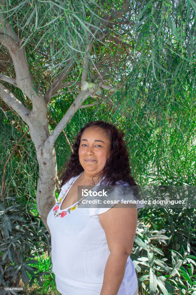 fat-mexican-woman-smiling-in-front-of-tree-in-park-indigenous.jpg